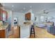 Open kitchen leads into the living room with a breakfast bar and hardwood floors at 15236 Waterfront Dr, Huntersville, NC 28078