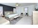 Large main bedroom with dark accent wall, ceiling fan, neutral paint, and ample natural light at 15236 Waterfront Dr, Huntersville, NC 28078