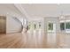 Expansive basement with hardwood floors, many windows, staircase, and a pendant light fixture at 15603 Mccullers Ct, Charlotte, NC 28277