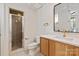 Bathroom with glass shower, modern vanity, and a large mirror with natural light from the doorway at 15603 Mccullers Ct, Charlotte, NC 28277