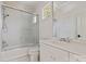 Clean, all-white bathroom with glass enclosed shower, sink with vanity, and a view from the window at 15603 Mccullers Ct, Charlotte, NC 28277
