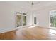 Bright, empty bedroom with hardwood floors, white trim, and large windows with lots of natural light at 15603 Mccullers Ct, Charlotte, NC 28277