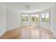 Bright, airy bedroom featuring beautiful hardwood floors and large windows with tree views at 15603 Mccullers Ct, Charlotte, NC 28277