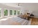 Bedroom featuring large windows, a light-colored rug, and a ceiling fan at 15603 Mccullers Ct, Charlotte, NC 28277