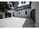 Wide driveway leading to multiple garage doors, showcasing the home's exterior and architectural details at 15603 Mccullers Ct, Charlotte, NC 28277