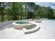 Outdoor hot tub and fire pit area with stone surround and landscaped backyard at 15603 Mccullers Ct, Charlotte, NC 28277