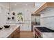 Bright kitchen features white cabinets, stainless appliances, and a marble countertop island at 15603 Mccullers Ct, Charlotte, NC 28277