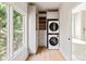 Laundry room features a stacked washer/dryer with built-in cabinets and drawers and window at 15603 Mccullers Ct, Charlotte, NC 28277