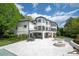 Expansive backyard with patio, lounge seating, fire pit, manicured lawn, and elegant modern architectural details at 15603 Mccullers Ct, Charlotte, NC 28277