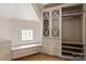 Bright walk-in closet featuring built-in drawers, cabinets, bench, and shelves with window at 15603 Mccullers Ct, Charlotte, NC 28277