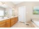 Bright bathroom with a double vanity, tile floors, neutral colors, and soaking tub at 158 Canopy Oak Ln, Statesville, NC 28625