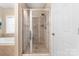 Bright bathroom featuring a tile shower with glass doors and tile surround at 158 Canopy Oak Ln, Statesville, NC 28625