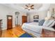 Bright bedroom featuring a tray ceiling, ceiling fan, hardwood floors, and coordinated decor at 158 Canopy Oak Ln, Statesville, NC 28625