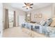 Bright bedroom featuring soft carpet, two windows, a large armoire, and queen-sized bed with decorative pillows at 158 Canopy Oak Ln, Statesville, NC 28625