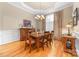 Formal dining room features hardwood floors, chandelier lighting, and elegant wainscoting at 158 Canopy Oak Ln, Statesville, NC 28625