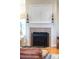 Living area fireplace with a decorative screen, mantle, and candle holders for a cozy ambiance at 158 Canopy Oak Ln, Statesville, NC 28625