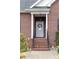 Covered front porch with stately columns and detailed front door at 158 Canopy Oak Ln, Statesville, NC 28625