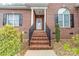Inviting front entrance with brick steps and decorative wreath at 158 Canopy Oak Ln, Statesville, NC 28625