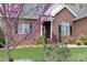 Charming front entrance with brick steps and blooming tree at 158 Canopy Oak Ln, Statesville, NC 28625