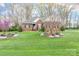Beautiful brick home featuring a lush green lawn and meticulously landscaped front yard at 158 Canopy Oak Ln, Statesville, NC 28625