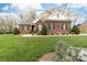 Well-maintained lawn and landscaping enhance this charming brick home at 158 Canopy Oak Ln, Statesville, NC 28625