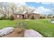 Charming brick home with meticulously maintained lawn and flowering shrubs at 158 Canopy Oak Ln, Statesville, NC 28625