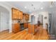 Spacious kitchen with wood cabinets, granite counters, an island, and stainless steel appliances at 158 Canopy Oak Ln, Statesville, NC 28625
