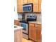 Modern kitchen appliances and wooden cabinets create a welcoming cooking space at 158 Canopy Oak Ln, Statesville, NC 28625