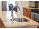 Close-up of kitchen island with granite countertop and stylish faucet at 158 Canopy Oak Ln, Statesville, NC 28625