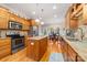Open concept kitchen with center island, stainless steel appliances, and granite countertops, ideal for entertaining at 158 Canopy Oak Ln, Statesville, NC 28625