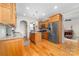 Large kitchen with wood cabinets, granite counters, center island, and modern stainless steel appliances at 158 Canopy Oak Ln, Statesville, NC 28625