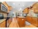 Well-equipped kitchen featuring a center island, stainless steel appliances, and an open layout to the dining area at 158 Canopy Oak Ln, Statesville, NC 28625