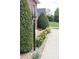 Landscaped walkway featuring vibrant flowers and manicured shrubs at 158 Canopy Oak Ln, Statesville, NC 28625