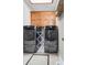 Functional laundry room featuring a full-sized washer and dryer, overhead cabinets and drying rack at 158 Canopy Oak Ln, Statesville, NC 28625