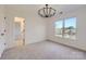 Bright bedroom features a contemporary chandelier and large windows, offering scenic outdoor views at 18038 Greyfield Gln, Fort Mill, SC 29707