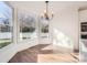 Bright dining area with hardwood floors, modern chandelier, and large windows providing natural light at 18038 Greyfield Gln, Fort Mill, SC 29707