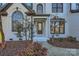 Inviting front entrance showcases a modern glass door and meticulous landscaping at 18038 Greyfield Gln, Fort Mill, SC 29707