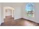 Elegant living room featuring hardwood floors, an arched doorway, and a large arched window with a view at 18038 Greyfield Gln, Fort Mill, SC 29707
