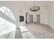 Bright living room with a fireplace, modern chandelier, and access to a hallway through double doors at 18038 Greyfield Gln, Fort Mill, SC 29707
