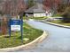Sign marking the amenity center in the Villages of Denver community, with the building visible in the background at 1814 Woods Ln, Denver, NC 28037