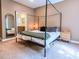 Cozy bedroom with a canopy bed, plush carpet, and bathroom access at 1814 Woods Ln, Denver, NC 28037