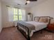 Serene bedroom features natural light, neutral walls, and carpet creating a relaxing atmosphere at 1814 Woods Ln, Denver, NC 28037