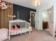 Cozy Bedroom offers a stylish accent wall and a relaxing sleeping space for your little one at 1814 Woods Ln, Denver, NC 28037