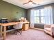 Well-lit home office space boasts a rustic desk and a cozy chair with great natural light at 1814 Woods Ln, Denver, NC 28037