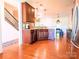 Open kitchen with granite countertops, stainless appliances, and a connecting dining area at 1814 Woods Ln, Denver, NC 28037
