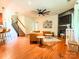Open-concept living area with staircase, hardwood floors, fireplace, and modern furnishings at 1814 Woods Ln, Denver, NC 28037