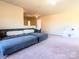 Carpeted living room featuring a comfortable sectional couch, and bright, neutral colored walls at 1814 Woods Ln, Denver, NC 28037
