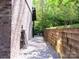 Well-maintained side yard featuring a brick wall, providing a private and tranquil outdoor space at 1814 Woods Ln, Denver, NC 28037