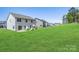Spacious backyard with lush lawn, a playset, and a patio, perfect for outdoor enjoyment at 2018 Sewall Sw Ave, Concord, NC 28025