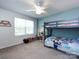 Bright bedroom with bunk beds, ceiling fan, large window, and teal accent wall at 2018 Sewall Sw Ave, Concord, NC 28025